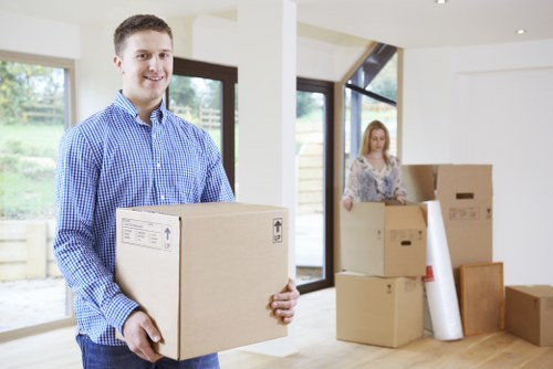 Moving team arranging packed items in a local North London property