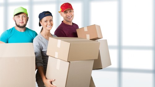 Driver loading household items into a moving van