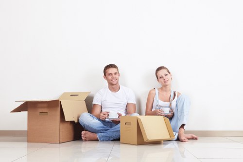 Trained movers handling furniture safely inside a removal van