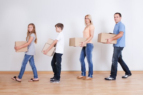 Careful lifting of a wardrobe during a local furniture removal